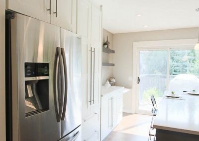 The sun shines into the kitchen reflecting off of the new white cabinets and creates such a bright fresh space. Interior Designer and Renovation Services in Calgary, Alberta.