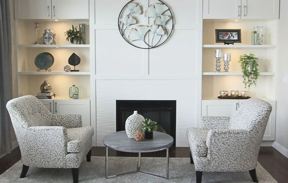 New fresh white panelling and sculptural tile surround this gorgeous fireplace. Calgary Interior Designer.