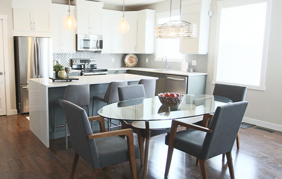 A beautiful kitchen with neutral details, pretty backsplash and fresh new countertops. Calgary Interior Designer.